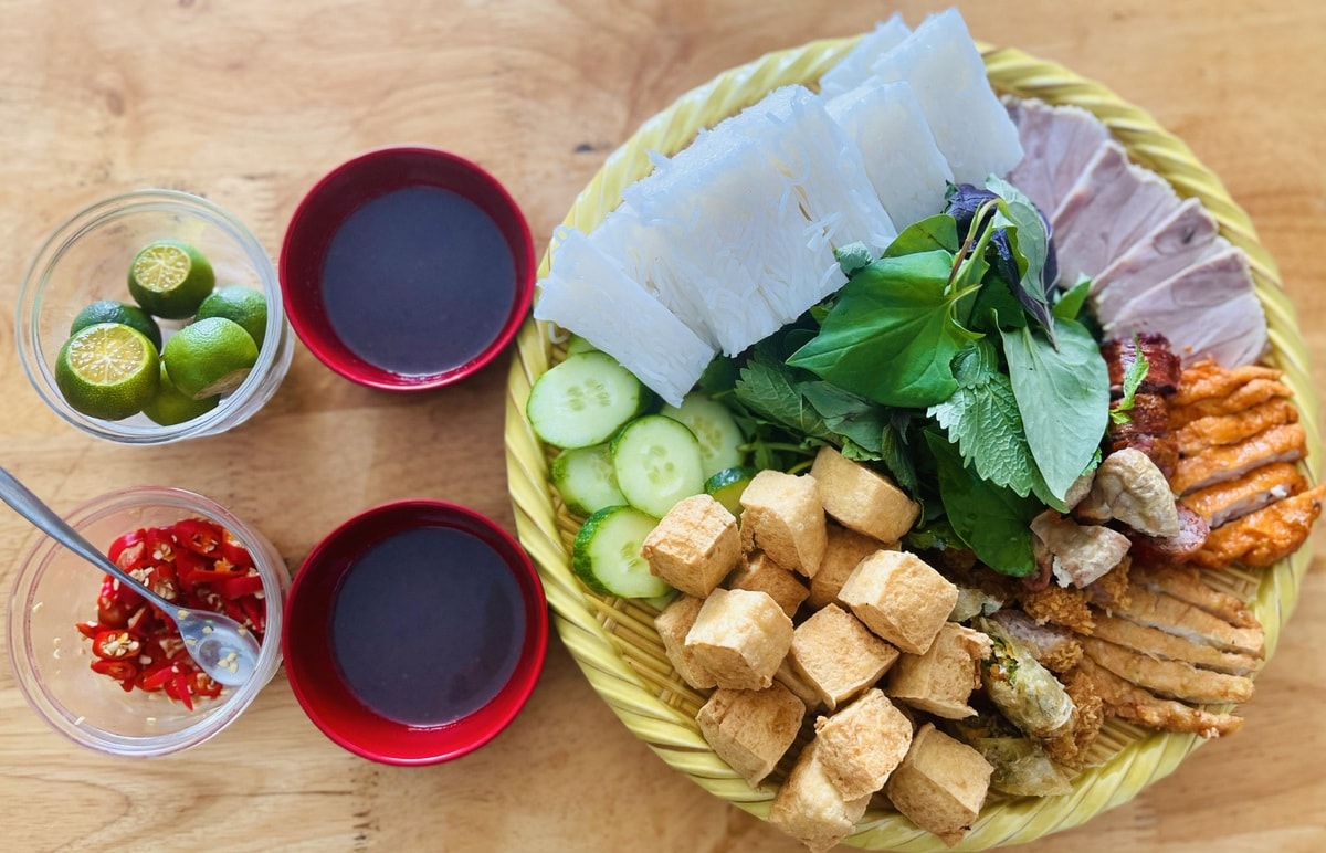 Locals savor Bun dau mam tom by mixing the shrimp paste with lime juice, sugar, chili, and eating it with various toppings